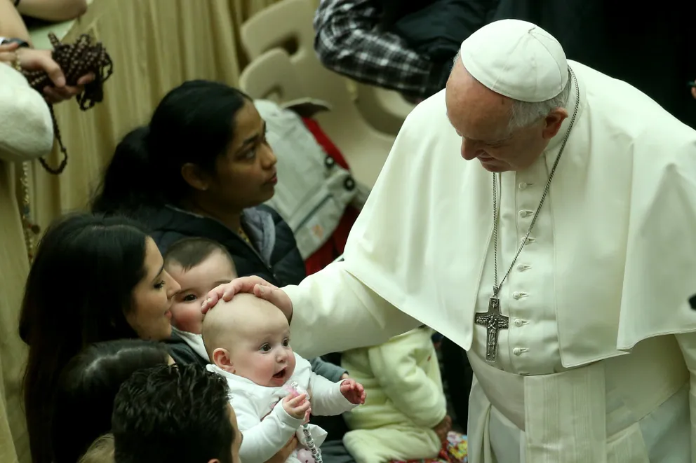 Pope Francis blessing a baby during his weekly audience at the Paul VI Hall in Vatican City, on February 12, 2020 | Source: Getty Images