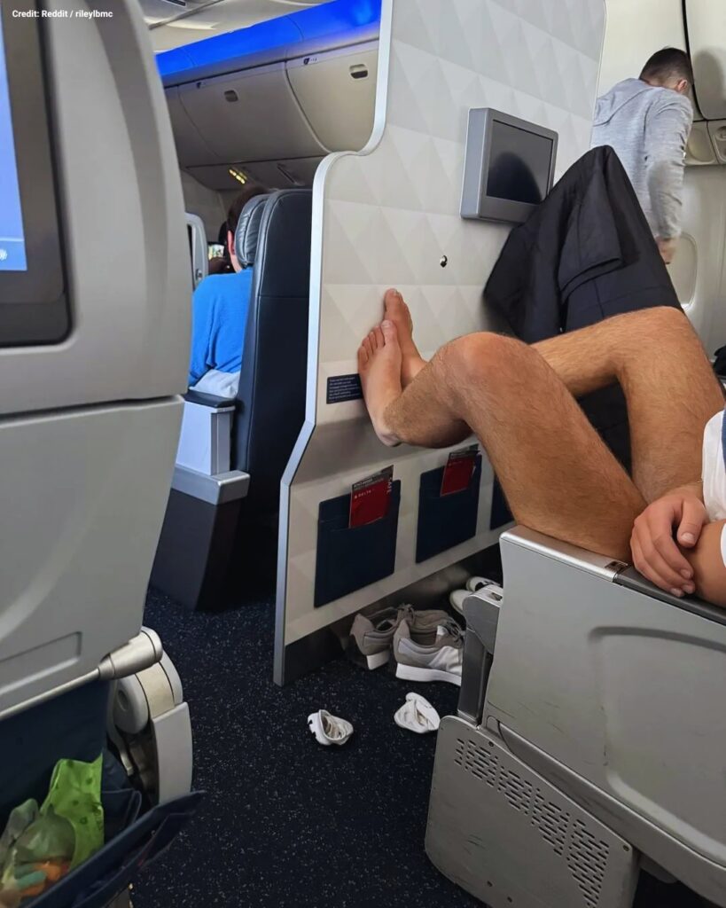 Redditors questioned a flight passenger putting his bare feet up on the back of seat. Reddit / rileylbmc